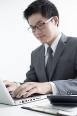 Handsome businessman working with laptop