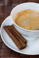 coffee cup  with cinnamon sticks