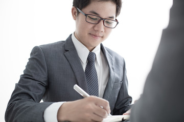 Two businessmen looking at report and having a discussion in off