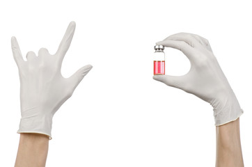 Fototapeta premium doctor's hand in a white glove holding a red vial of liquid