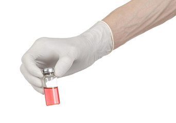 doctor's hand in a white glove holding a red vial of liquid