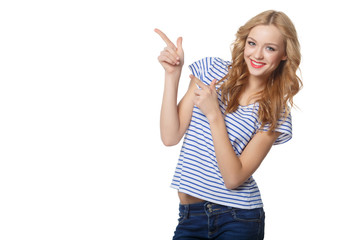 Young woman pointing at blank copy space, isolated over white
