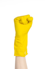 man's hand holding a yellow and wears rubber gloves in studio