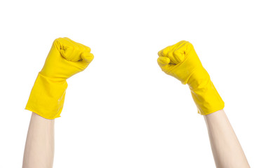 man's hand holding a yellow and wears rubber gloves in studio