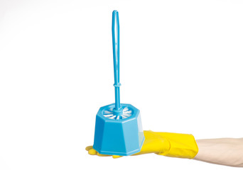 Fototapeta premium human hand holding a blue toilet brush in yellow gloves