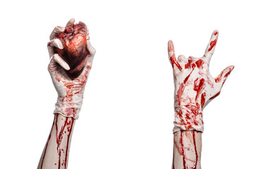 Bloody hand surgeon holding a human heart in a white gloves