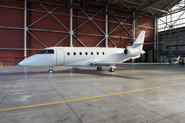 Business jet airplane is in hangar.