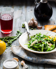 green salad with arugula, cheese, almonds, red wine