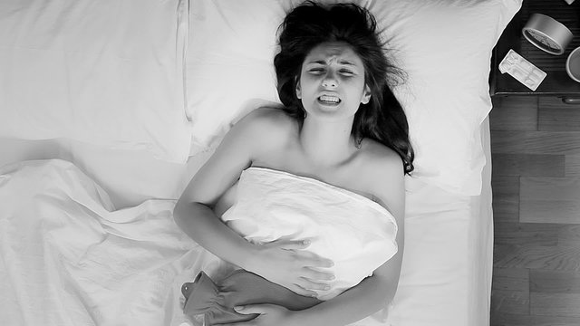 Beautiful woman suffering pain because of stomac ache