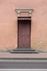 The wooden door to the street in an old house