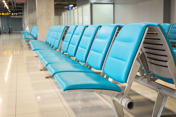 row of blue chair in the airport