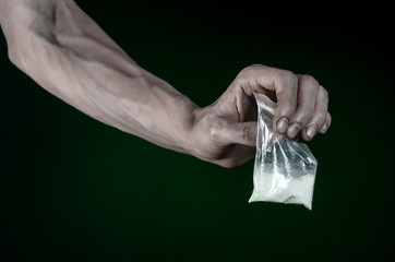 dirty hand holding a bag addict cocaine in the studio
