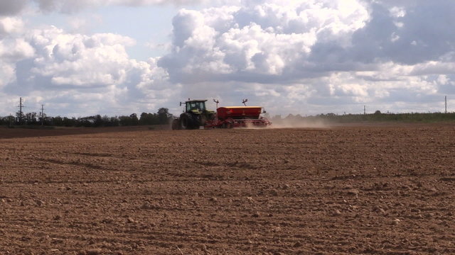 Tractor fertilizer prepare soil in field. Planting crops