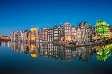 Fototapeta na wymiar Beautiful night skyline of Amsterdam. City homes along canal