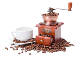 Old fashioned coffee ginder with cup and beans