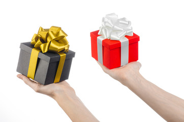 hand holding two gift wrapped in red box and a black box studio