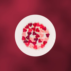 Colored heart shape jellies on a white plate