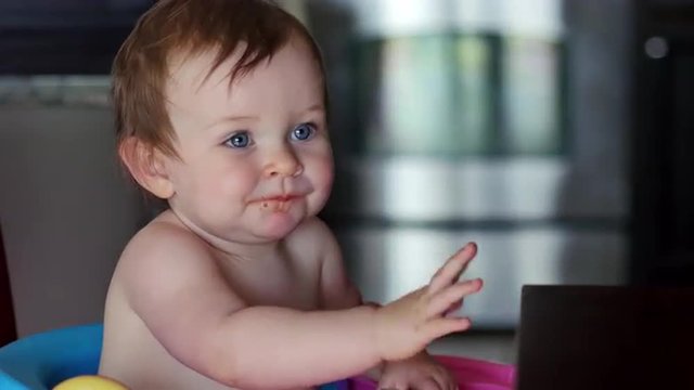 Cute baby waves and smiles while eating dinner, 4K