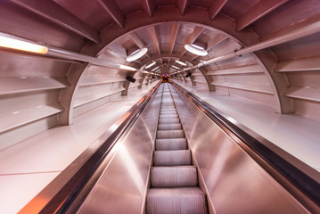 Moving blurred picture of escalator inside a tunnel