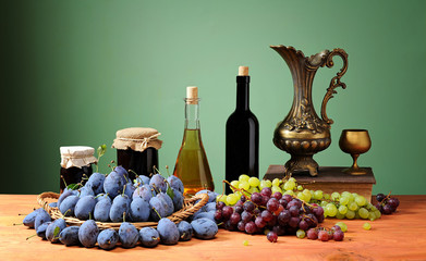 Fresh plum, brandy, grape and plum jam on the table