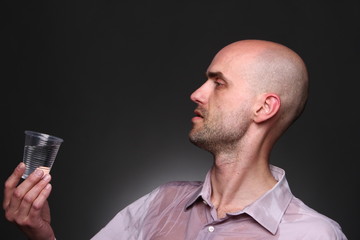 man drink water ore vodka with drops