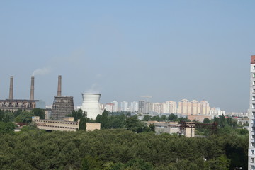 Fototapeta na wymiar Chimney of a Power plant against blue sky