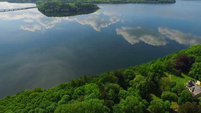 aerial flight over a lake in sunny wheather and beautiful clouds