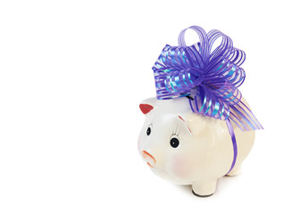 Piggy bank with big violet bow isolated on white..
