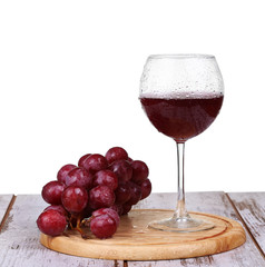 wine pouring into glass with grape and bottles isolated