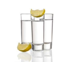 Three  tequila shots with lime isolated on white background