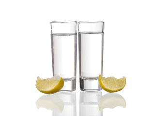 Three  tequila shots with lime isolated on white background