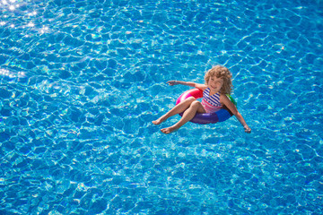 Happy child playing in swimming pool