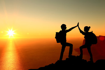 The Silhouette of two man with success gesture standing 