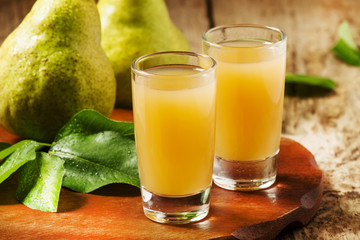 Pear fresh juice and pear on a wooden table, selective focus