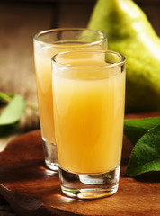 Pear fresh juice and pear on a wooden table, selective focus