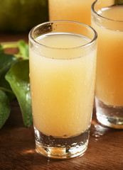 Pear fresh juice and pear on a wooden table, selective focus