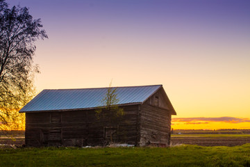 Fototapeta na wymiar Crooked Barn House In The Sunset