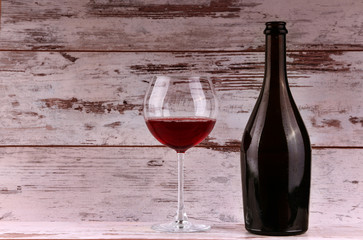 Red wine bottle on a wooden background
