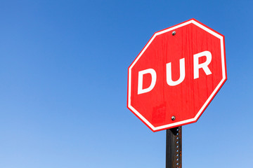 Turkish stop road sign over clear blue sky