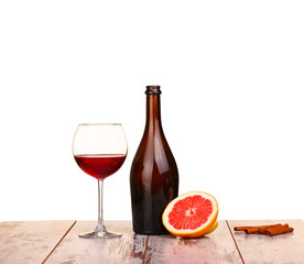 glass of red wine, a bottle of wine and grapefruit  isolated 