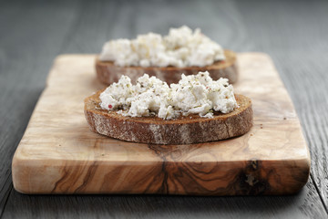 rye sandwich or bruschetta with ricotta cheese and herbs