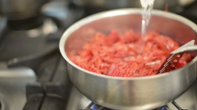 cooking king shrimp in pan 
