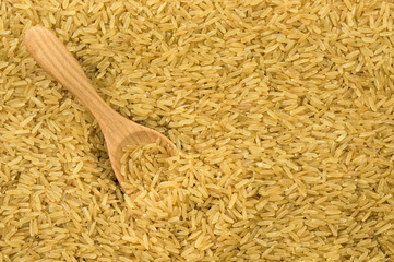 Brown rice with wooden spoon