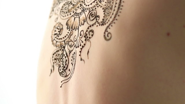 Mehendi. Creating complex pattern on model's back 
