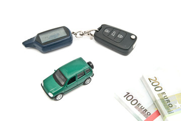 green car, keys and banknotes on white