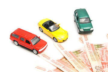 different cars and Russian banknotes