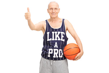 Senior holding basketball and giving a thumb up