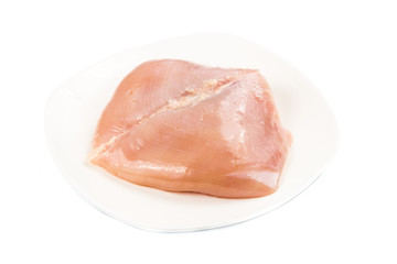 Fresh heart shaped skinless chicken breast meat on a plate