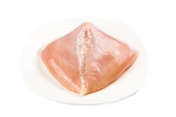 Fresh heart shaped skinless chicken breast meat on a plate