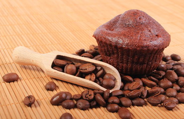 Fresh baked chocolate muffins and coffee grains